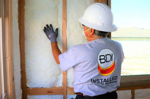 Big City Insulation of Idaho technician installing insulation