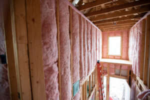 a building under construction with pink insulation
